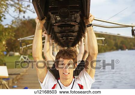 Crew holding boat above heads. View Large Photo Image Stock Image - Crew holding boat above heads.. Fotosearch
