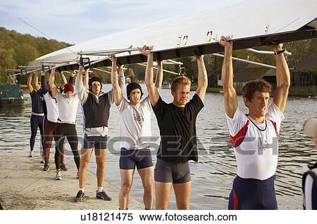 Crew holding boat above heads. View Large Photo Image Stock Photography - Crew holding boat above heads.. Fotosearch