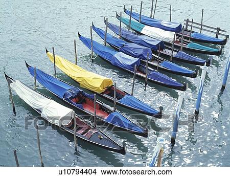 Picture - Eight docked gondolas in Venice.. Fotosearch