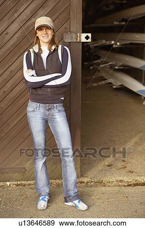 Female standing outside boatshed. View Large Photo Image Stock Photo - Female standing outside boatshed.. Fotosearch