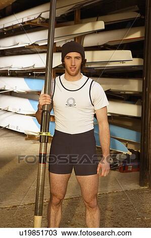 Oarsman outside boat shed. View Large Photo Image Stock Image - Oarsman outside boat shed.. Fotosearch