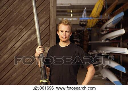 Oarsman outside boat shed. View Large Photo Image Stock Photograph - Oarsman outside boat shed.. Fotosearch