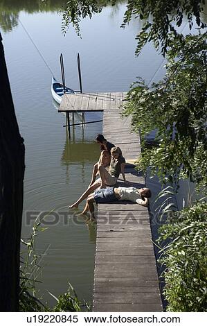 Stock Photography - Three young women on a pier.. Fotosearch