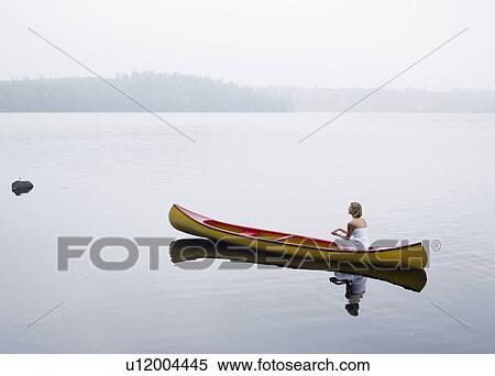 Stock Photography - Woman sitting in a boat.. Fotosearch