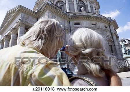 Stock Photo - Couple taking picture of church. Fotosearch