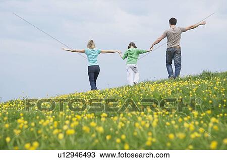 Family walk in field View Large Photo Image Stock Image - Family walk in field. Fotosearch