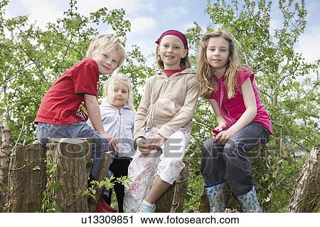 Stock Image - Four children in a tree. Fotosearch