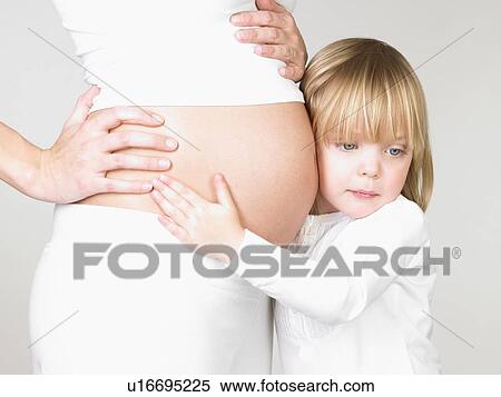 Girl holding her mother's pregnant belly View Large Photo Image Stock Photography - Girl holding her mother's pregnant belly. Fotosearch