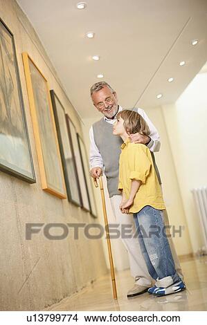 Picture - Grandfather with grandson in art gallery. Fotosearch