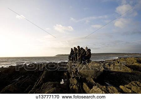 Group of Friends sitting on rock View Large Photo Image Stock Image - Group of Friends sitting on rock. Fotosearch