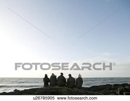 Group of Friends sitting on rock View Large Photo Image Stock Photography - Group of Friends sitting on rock. Fotosearch