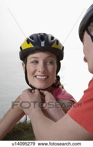 Man adjusting a Woman's cycle helmet. View Large Photo Image Stock Photo - Man adjusting a Woman's cycle helmet.. Fotosearch