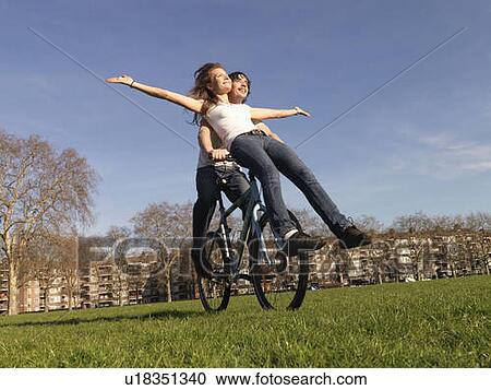 Man and woman riding bicycle View Large Photo Image Stock Image - Man and woman riding bicycle. Fotosearch