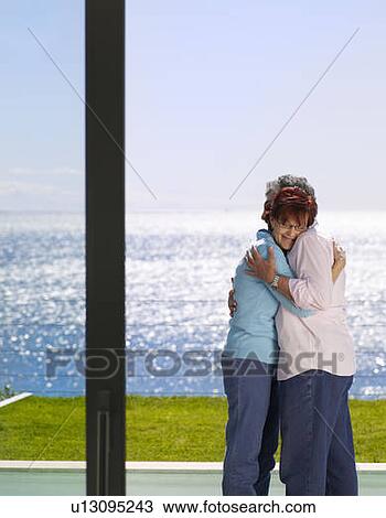 Stock Image - Mature man and woman embracing outside. Fotosearch