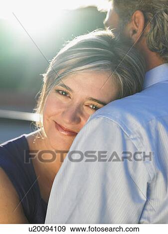 Stock Photo - Mature man embracing mature woman. Fotosearch