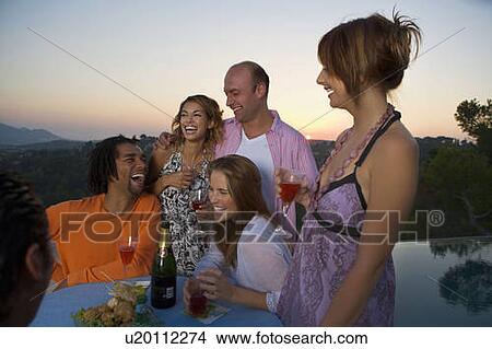 Men and woman at a party at sunset View Large Photo Image Picture - Men and woman at a party at sunset. Fotosearch