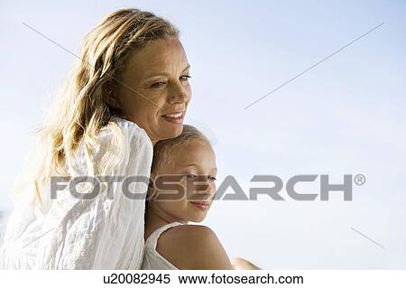 Stock Photography - Mother and daughter sitting together. Fotosearch