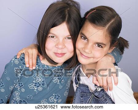 Stock Image - Portrait of two girls smiling. Fotosearch