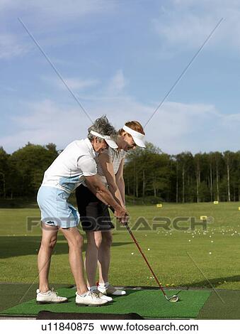 Two women at driving range View Large Photo Image Stock Photography - Two women at driving range. Fotosearch