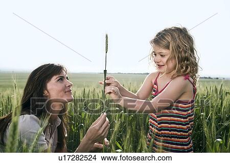 Picture - Woman and child holding wheat. Fotosearch