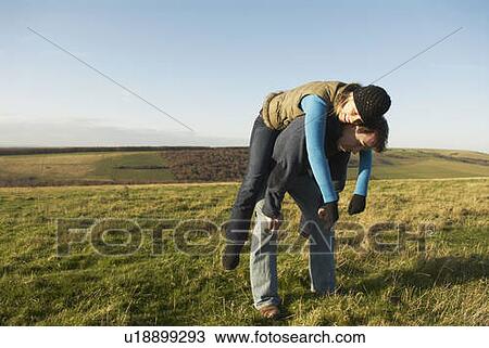 Woman rests on man's back View Large Photo Image Stock Image - Woman rests on man's back. Fotosearch
