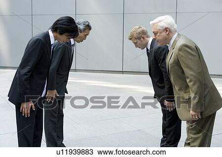 Stock Image - Businessmen Bowing. Fotosearch