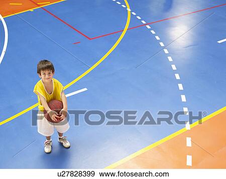 Boy holding basket ball (portrait, high angle view) View Large Photo Image Stock Photo - Boy holding basket ball (portrait, high angle view). Fotosearch