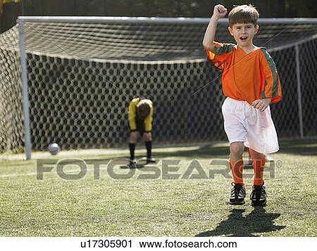 Boy in soccer uniform celebrating, defeated goalkeeper in background (portrait) View Large Photo Image Stock Image - Boy in soccer uniform celebrating, defeated goalkeeper in background (portrait). Fotosearch