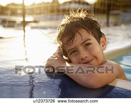 Boy in swimming pool (portrait) View Large Photo Image Stock Photograph - Boy in swimming pool (portrait). Fotosearch