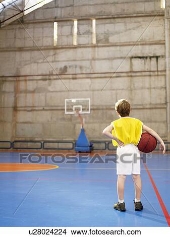 Boy looking at basketball hoop (rear view) View Large Photo Image Picture - Boy looking at basketball hoop (rear view). Fotosearch