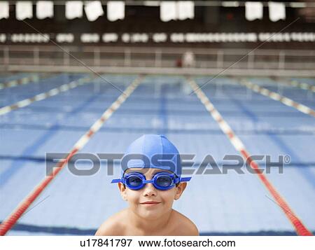 Boy wearing goggles by swimming pool (portrait) View Large Photo Image Stock Photo - Boy wearing goggles by swimming pool (portrait). Fotosearch