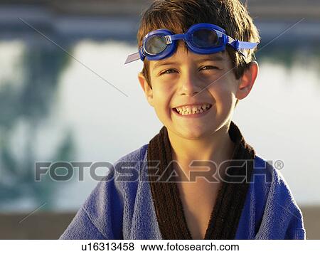 Boy wearing swimming goggles and gown (portrait) View Large Photo Image Stock Photo - Boy wearing swimming goggles and gown (portrait). Fotosearch