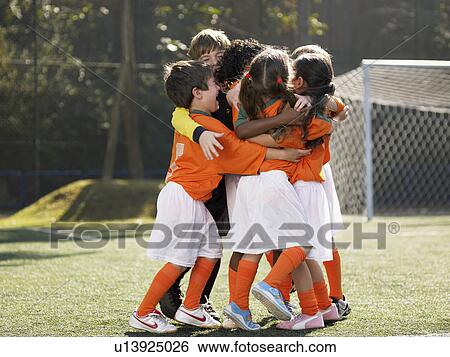 Children in soccer uniforms hugging View Large Photo Image Stock Photograph - Children in soccer uniforms hugging. Fotosearch