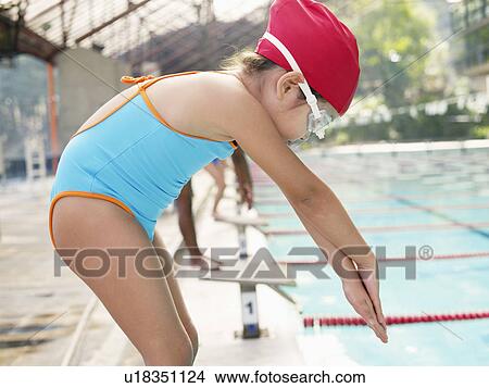 Picture - Girl at starting block for swimming race. Fotosearch