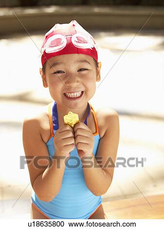 Girl in swimming costume holding first prize (portrait) View Large Photo Image Stock Image - Girl in swimming costume holding first prize (portrait). Fotosearch
