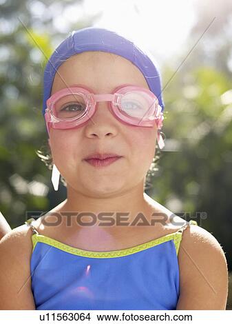 Picture - Girl wearing swimming goggles and cap (portrait). Fotosearch
