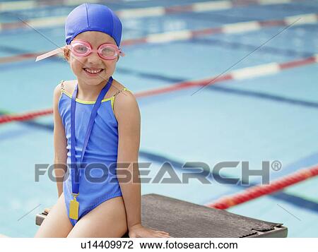 Girl wearing swimming goggles by pool (portrait) View Large Photo Image Stock Image - Girl wearing swimming goggles by pool (portrait). Fotosearch