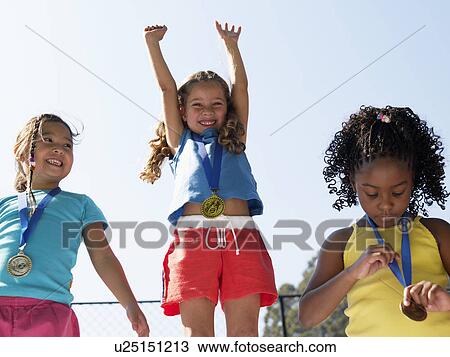 Girls celebrating on winners podium (low angle view) View Large Photo Image Stock Image - Girls celebrating on winners podium (low angle view). Fotosearch