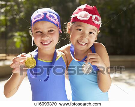 Girls in swimming costumes holding medals (portrait) View Large Photo Image Stock Image - Girls in swimming costumes holding medals (portrait). Fotosearch