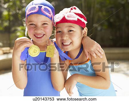 Girls in swimming costumes holding medals (portrait) View Large Photo Image Stock Image - Girls in swimming costumes holding medals (portrait). Fotosearch