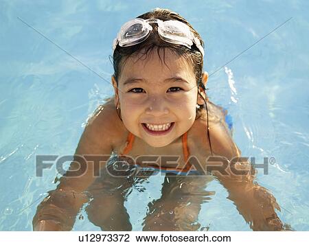 Young girl in swimming pool (portrait, high angle view) View Large Photo Image Stock Image - Young girl in swimming pool (portrait, high angle view). Fotosearch