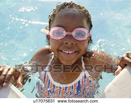 Young girl wearing swimming goggles in pool (portrait) View Large Photo Image Stock Image - Young girl wearing swimming goggles in pool (portrait). Fotosearch