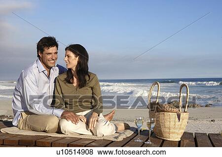 Couple drinking wine on beach, Cape Town, South Africa View Large Photo Image Stock Photo - Couple drinking wine on beach, Cape Town, South Africa. Fotosearch