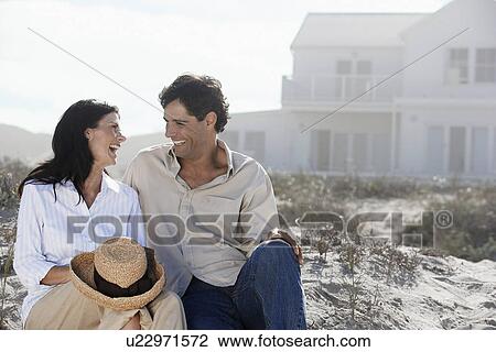 Couple laughing at beach View Large Photo Image Stock Image - Couple laughing at beach. Fotosearch