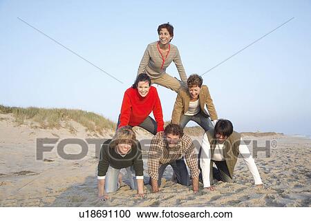 Five people forming human pyramid (portrait) View Large Photo Image Stock Image - Five people forming human pyramid (portrait). Fotosearch