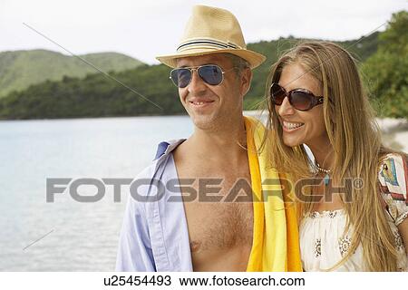 Mid adult couple on beach View Large Photo Image Stock Image - Mid adult couple on beach. Fotosearch