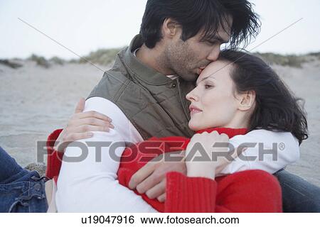 Young couple hugging on beach View Large Photo Image Stock Photograph - Young couple hugging on beach. Fotosearch