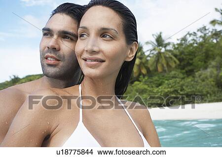 Young couple looking at view near beach, St. John, US Virgin Islands, USA View Large Photo Image Picture - Young couple looking at view near beach, St. John, US Virgin Islands, USA. Fotosearch