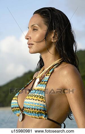 Young woman in bikini at dusk View Large Photo Image Stock Image - Young woman in bikini at dusk. Fotosearch