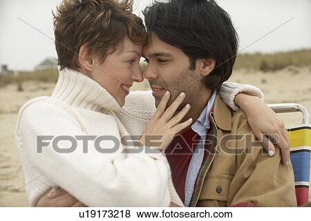 Couple hugging on lounge chair View Large Photo Image Stock Photo - Couple hugging on lounge chair. Fotosearch
